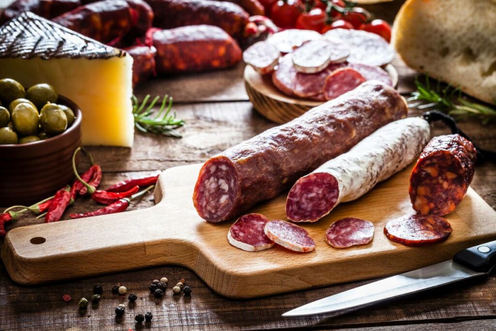 Mixed spanish chorizo pieces on a cutting board